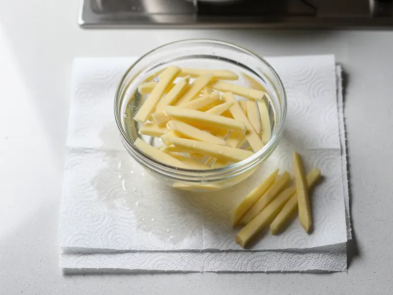 Step 2: Soak the cut potatoes in cold water for 20 minutes to remove surface starch. Dra