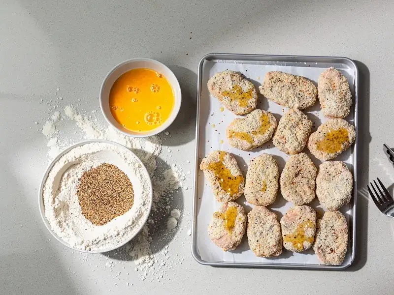 Step 3: Dip each chicken piece into the beaten egg, then coat thoroughly in the flour mi