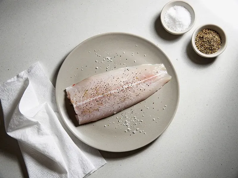 Step 1: Pat the fish fillet dry with paper towels and season lightly with salt and peppe