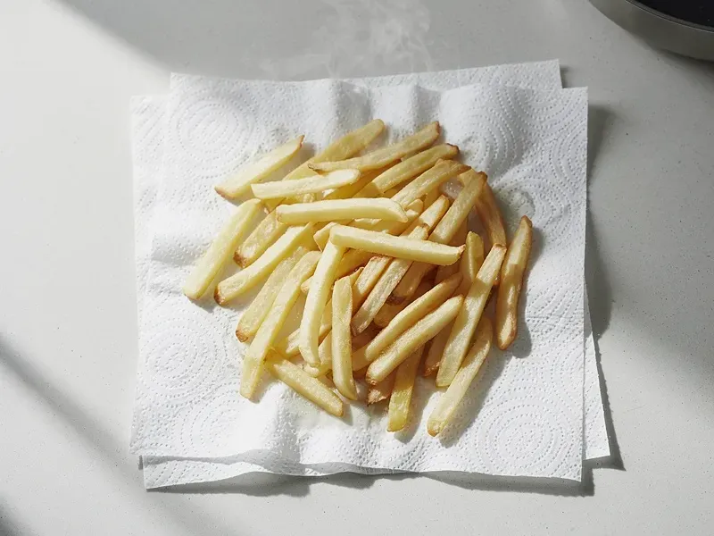 Step 2: Drain the fries and pat them thoroughly dry with paper towels. Removing moisture