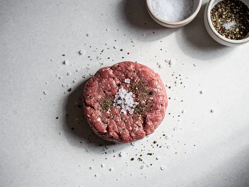 Step 1: Season the beef patty with salt and pepper on both sides.
