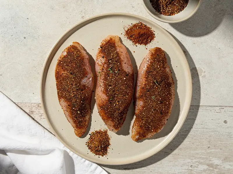 Step 2: Pat the chicken strips dry with paper towels. Press the seasoning blend firmly o