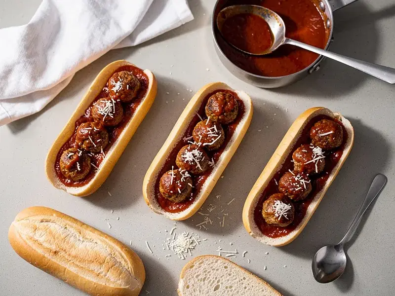 Step 7: Spoon 4 to 5 meatballs into each roll along with a generous ladle of marinara sa
