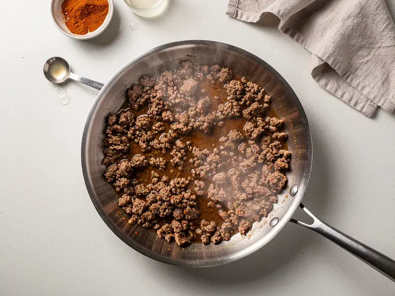 Step 2: Brown the ground beef in a separate skillet over medium-high heat. Drain fat, ad